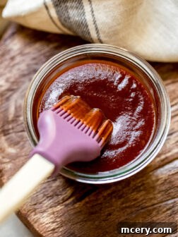 Homemade 3-Ingredient Barbecue Sauce in a jar with a basting brush, ready for use.