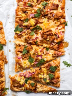 bbq chicken flatbread on white parchment paper.