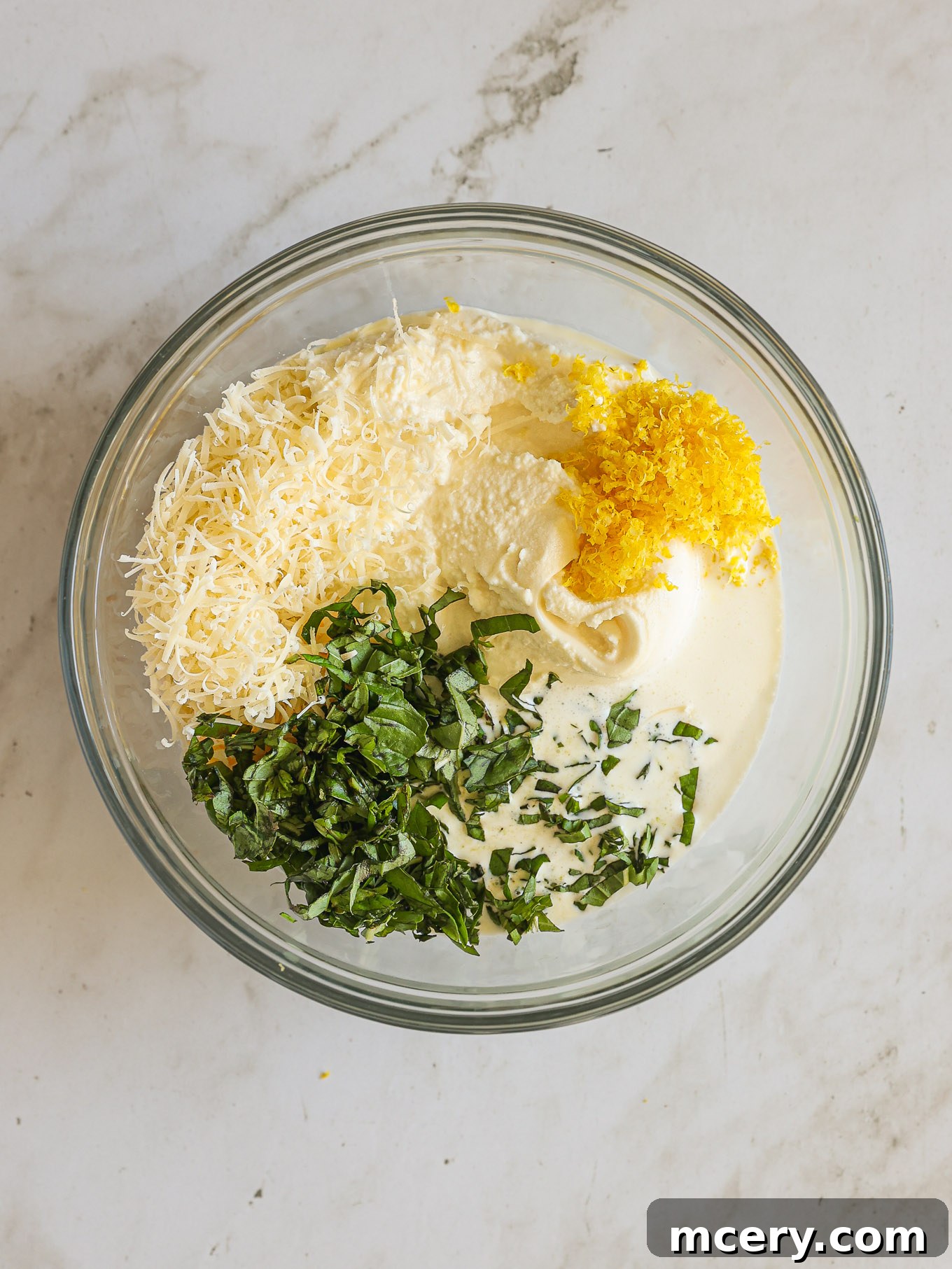 Golden Baked Ziti Delight 7 Creamy ricotta cheese mixture with Parmesan and fresh basil in a glass bowl.