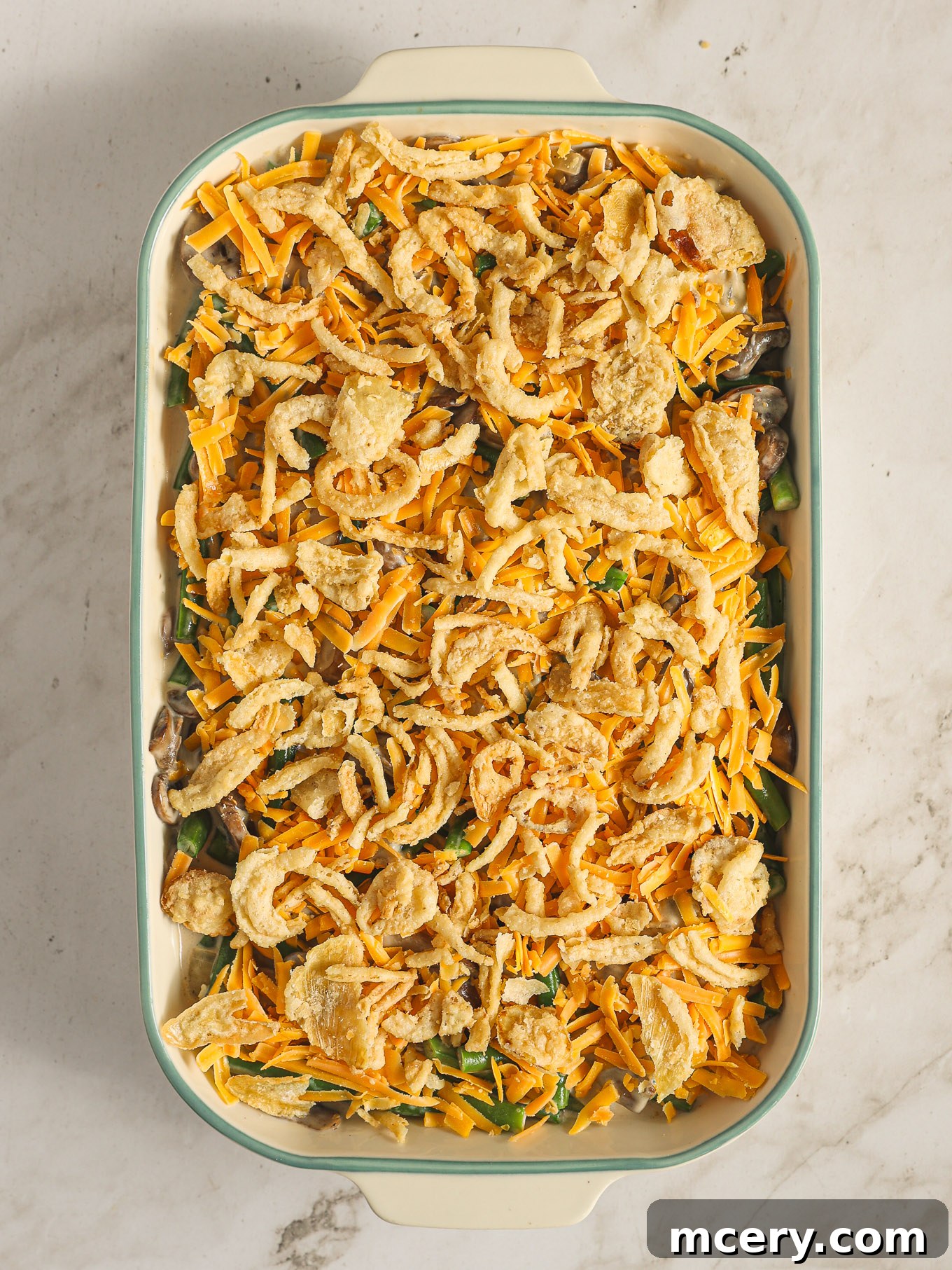 The Ultimate Green Bean Casserole 11 green bean casserole topped with crispy fried onions.