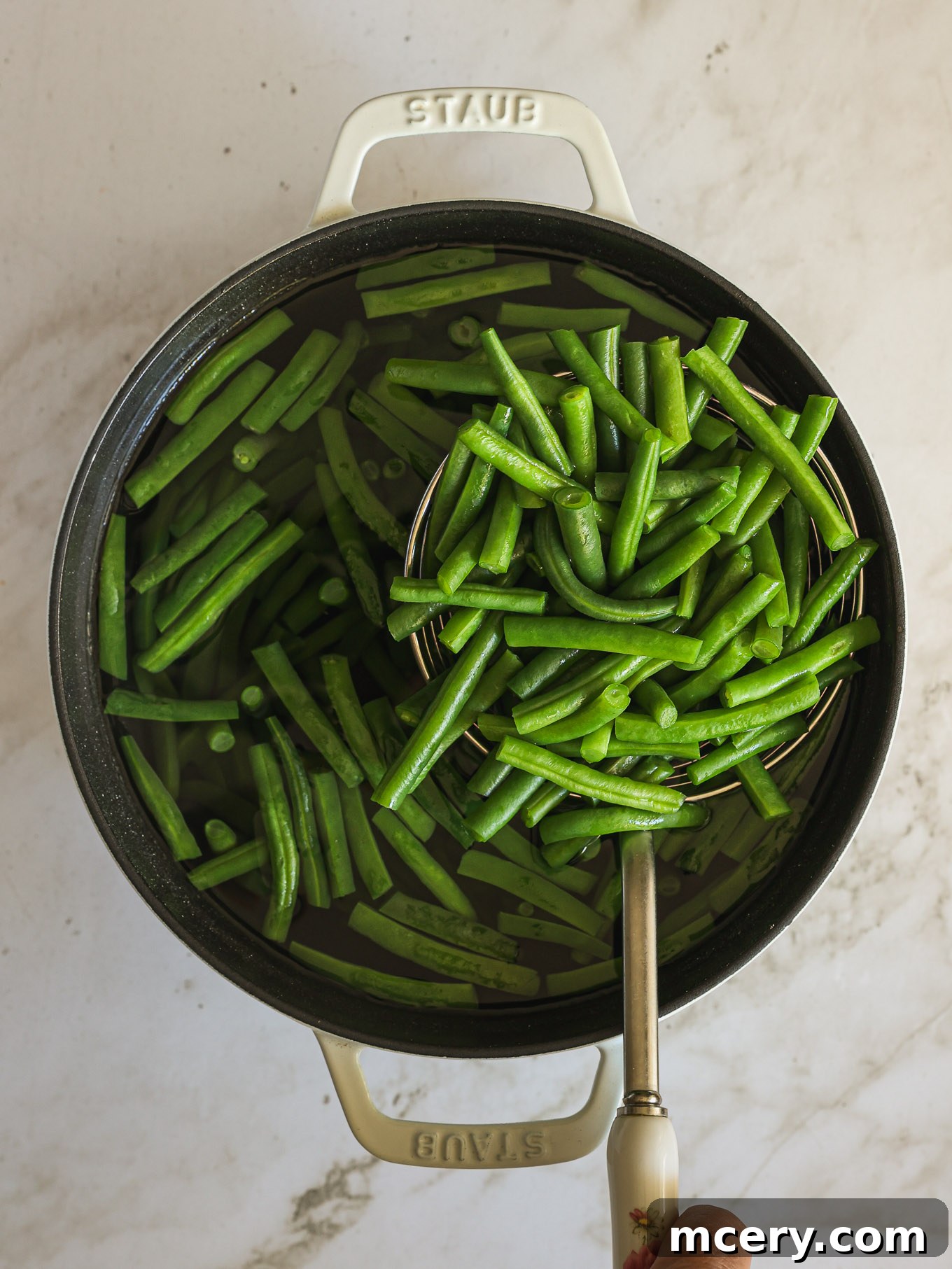 The Ultimate Green Bean Casserole 4 blanched green beans in a pot.