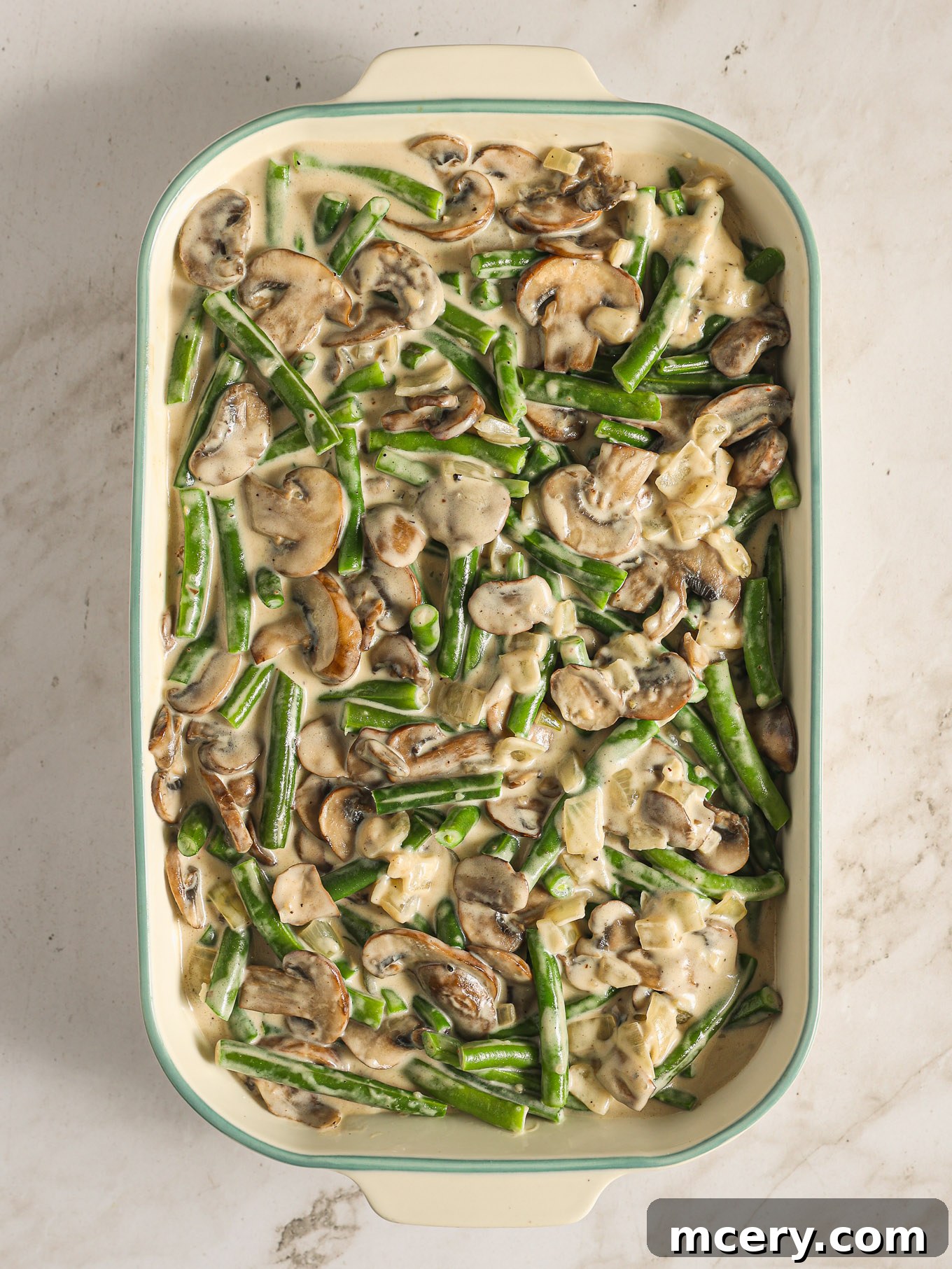 The Ultimate Green Bean Casserole 10 assembled green bean casserole in a baking dish.