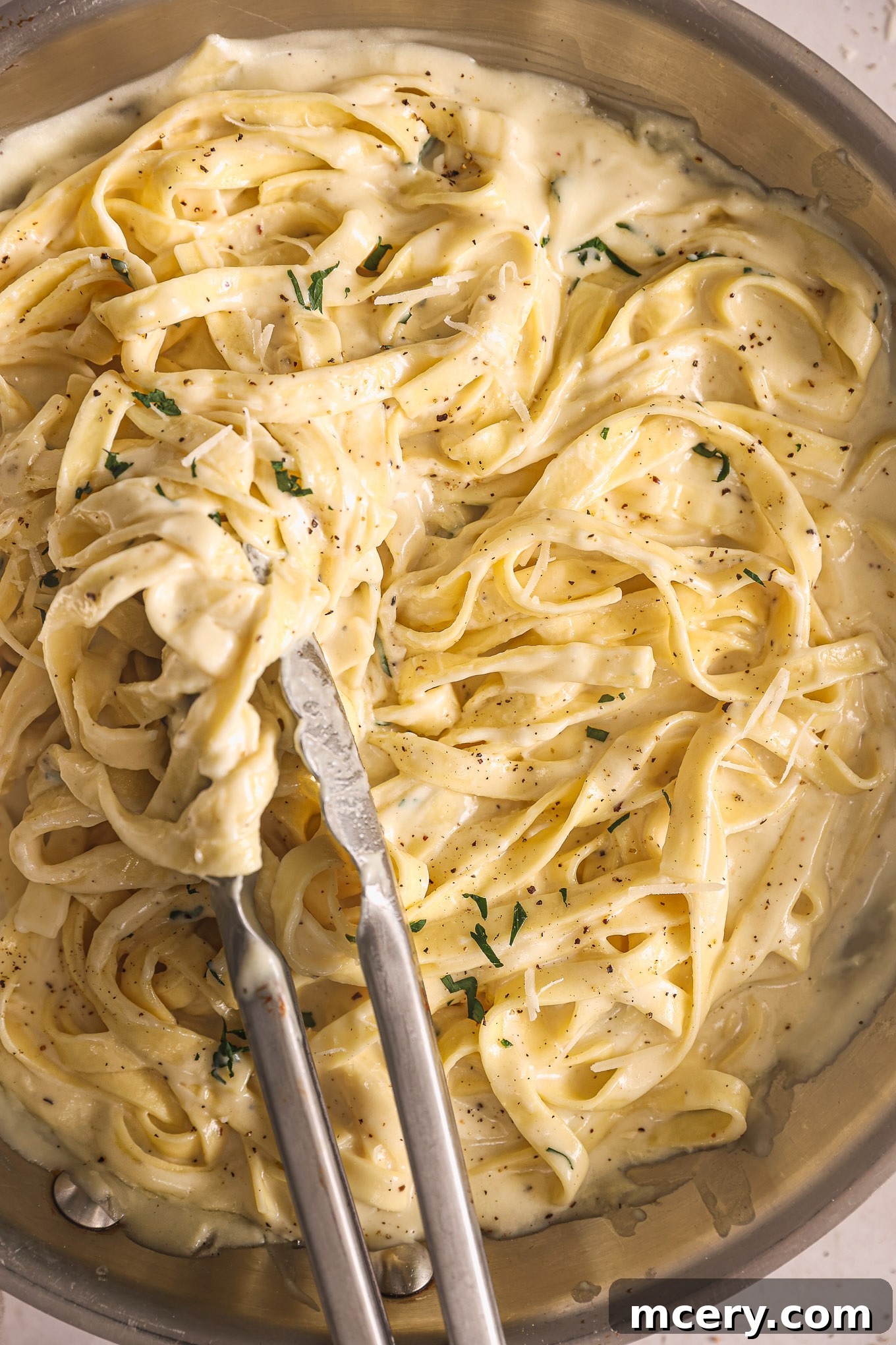 Homemade Alfredo Perfection 2 Fettuccine pasta generously coated in homemade Alfredo sauce, served in a pan.