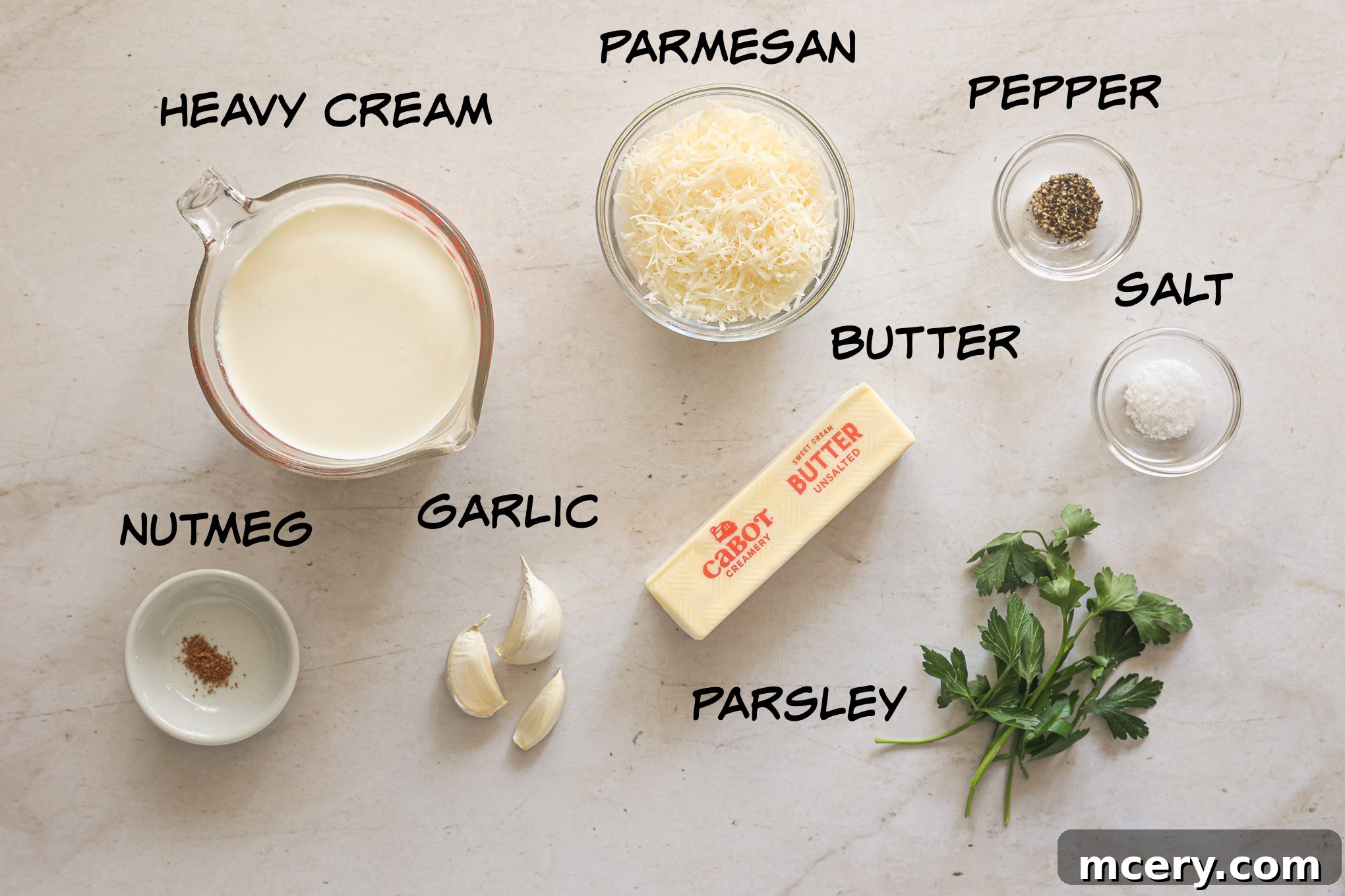 Homemade Alfredo Perfection 3 A selection of fresh ingredients laid out, including butter, heavy cream, garlic, and Parmesan cheese, ready for making Alfredo sauce.