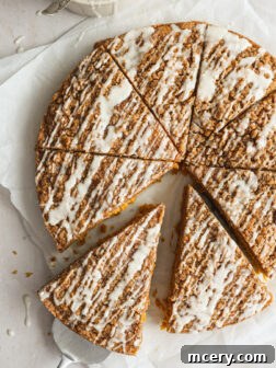 A beautifully presented slice of pumpkin coffee cake, showcasing its moist texture, rich streusel, and delicate glaze.