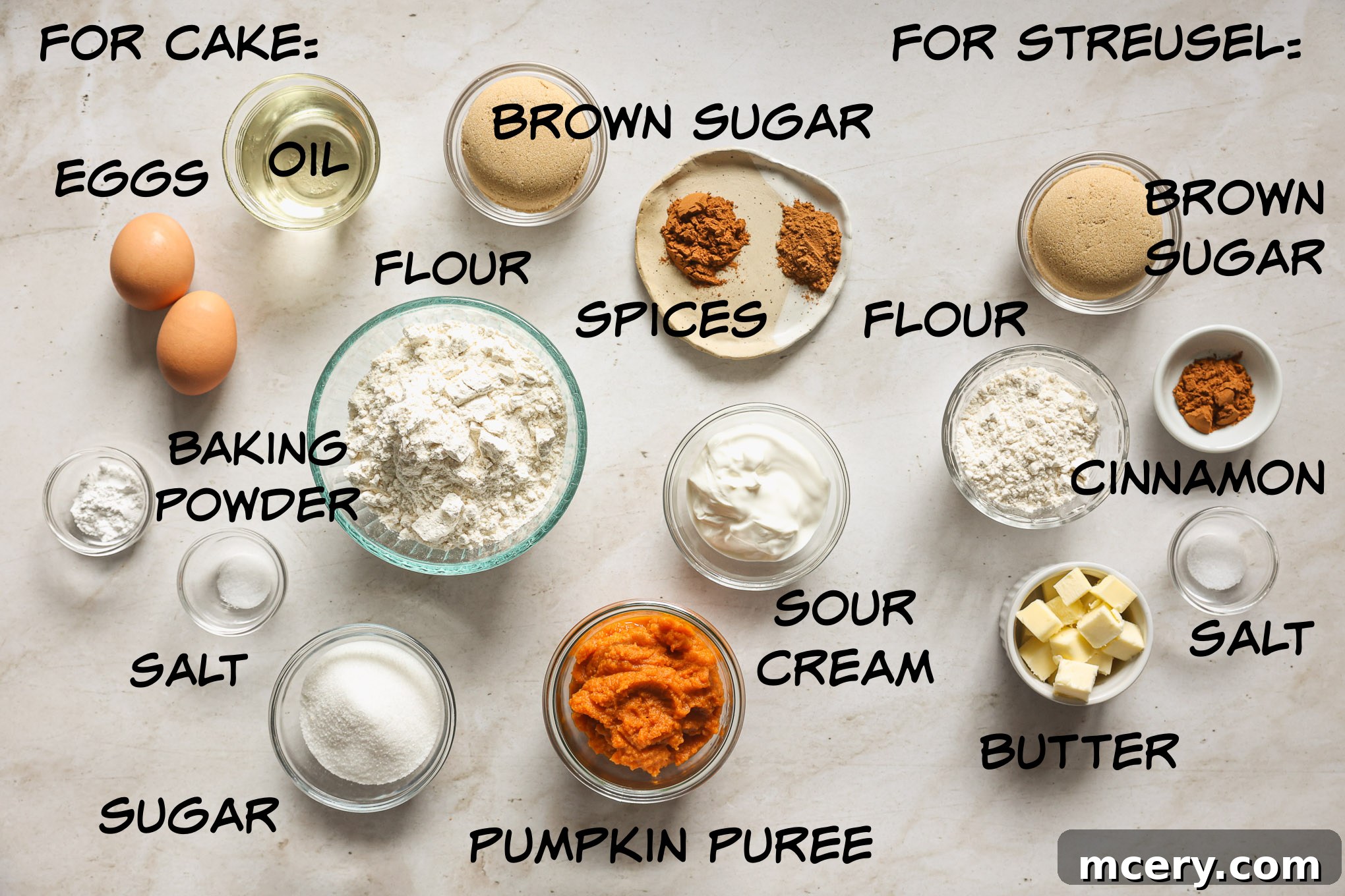 Cozy Pumpkin Crumble Coffee Cake 3 An assortment of dry and wet ingredients for pumpkin coffee cake, including flour, sugar, spices, pumpkin puree, and eggs, neatly laid out on a kitchen surface.