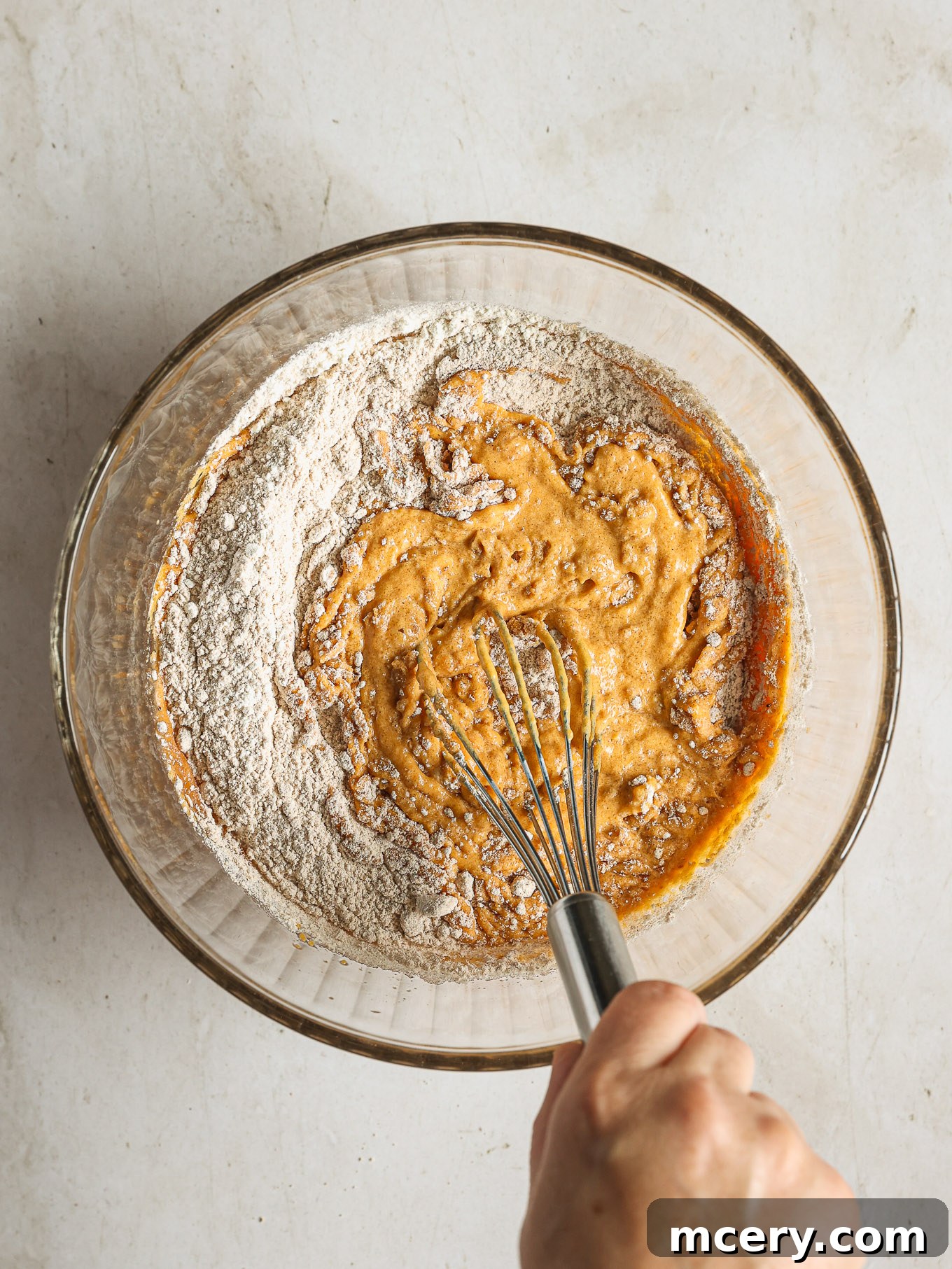 Cozy Pumpkin Crumble Coffee Cake 8 The dry and wet ingredients for the coffee cake batter are gently folded together in a mixing bowl until just combined, with a few small lumps remaining.