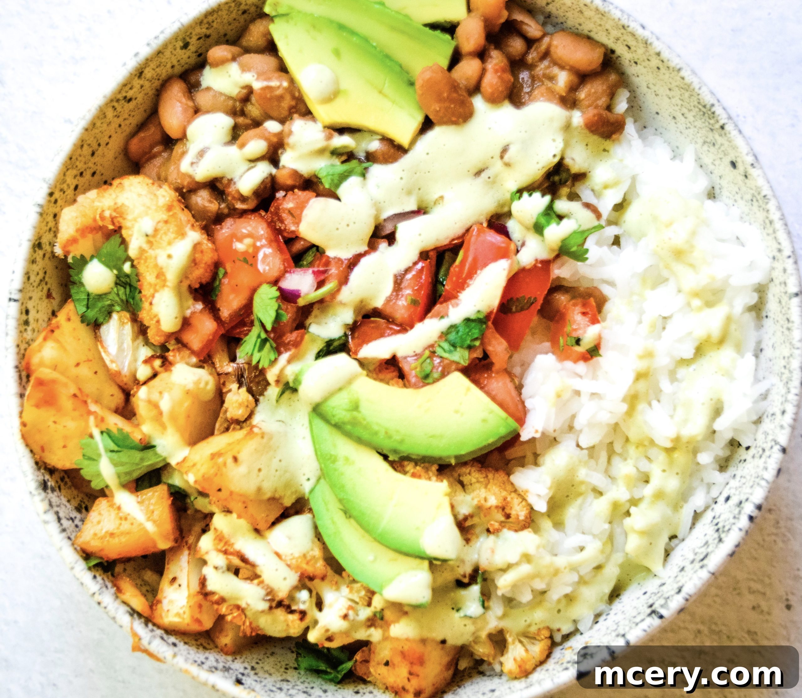 Taco Roasted Cauliflower and Potatoes with a Creamy Dip 6 Assortment of taco fillings including taco spiced cauliflower and potatoes, beans, pico de gallo, and avocado, arranged for a delicious meal
