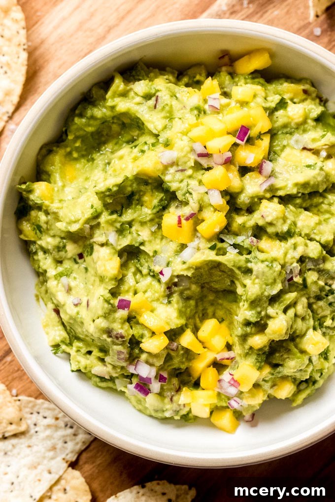 Tropical Mango Guacamole 6 Close-up of freshly made mango guacamole in a bowl, garnished with cilantro