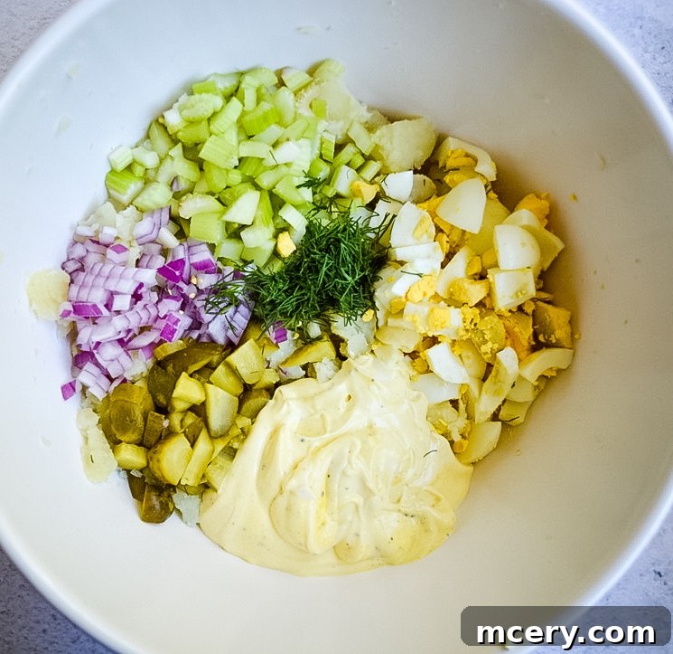 Grandma's Best Potato Salad 4 A rustic bowl of classic potato salad on a wooden surface, garnished with fresh dill.