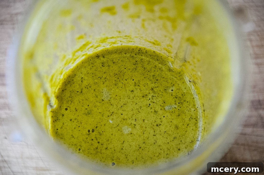 Fresh ingredients for the marinade in a blender cup, ready to be blended.