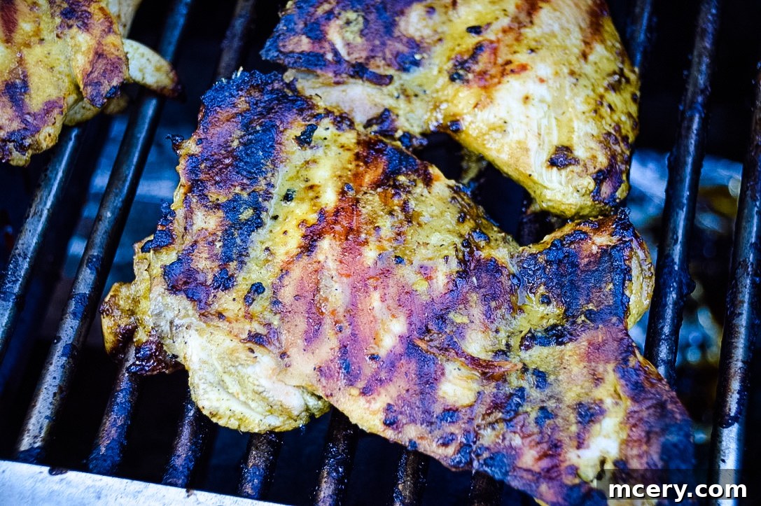 Grilled Tequila Lime Chicken thighs with perfect char marks on the grill grates.