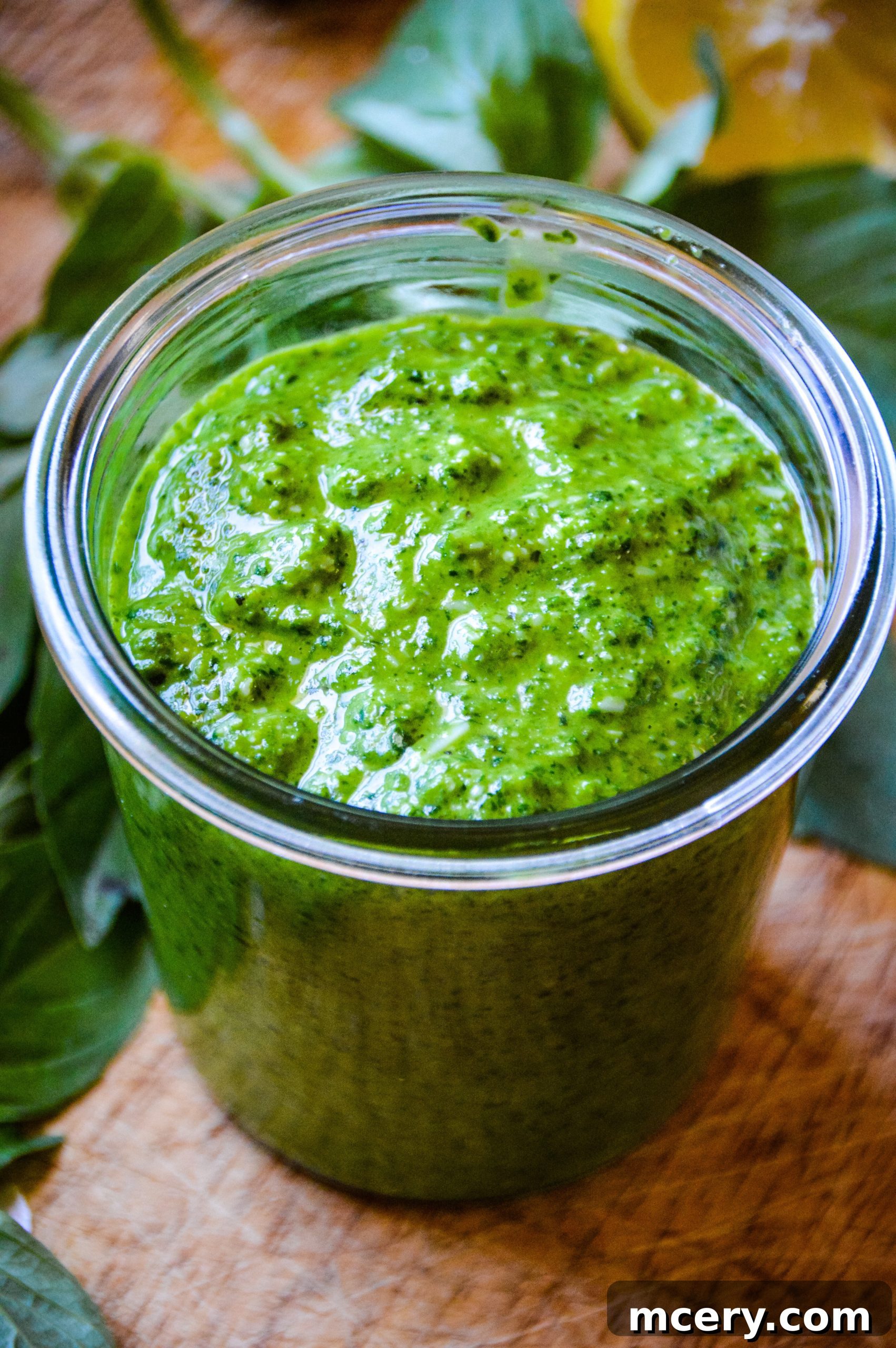 Homemade Spinach Basil Pesto A bowl of freshly made green spinach basil pesto, vibrant and textured, ready to be mixed into pasta.