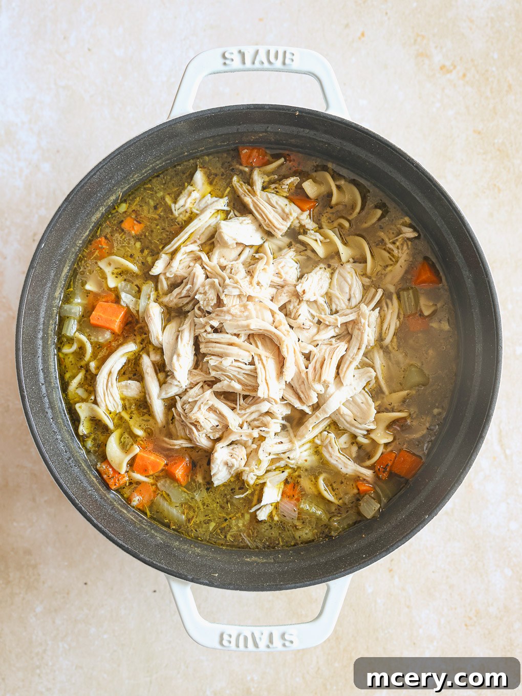 Cozy Homemade Chicken Noodle Soup 11 chicken soup in a pot with shredded chicken.