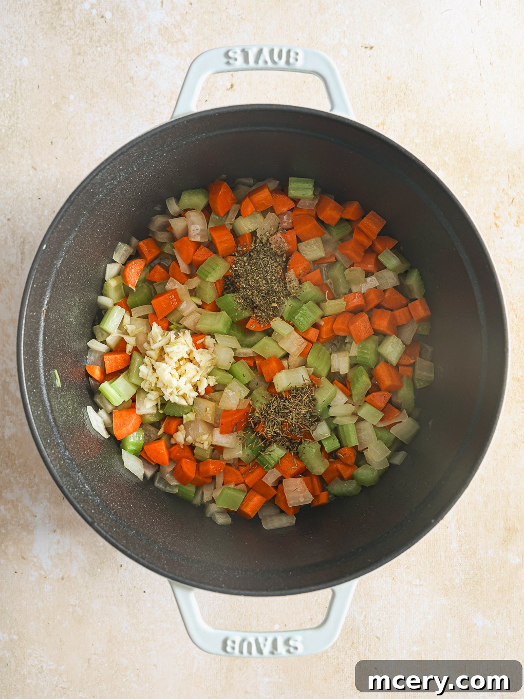 Cozy Homemade Chicken Noodle Soup 8 diced vegetables in a pot.