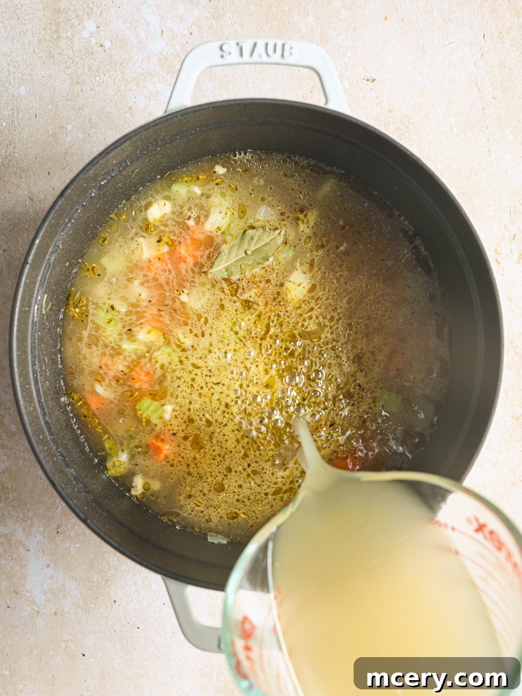 Cozy Homemade Chicken Noodle Soup 9 chicken stock in pot.