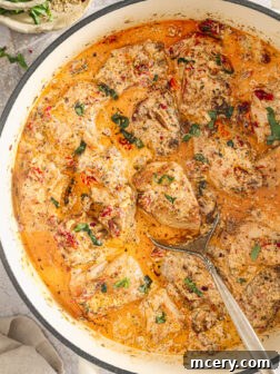 chicken in cream sauce in a skillet.
