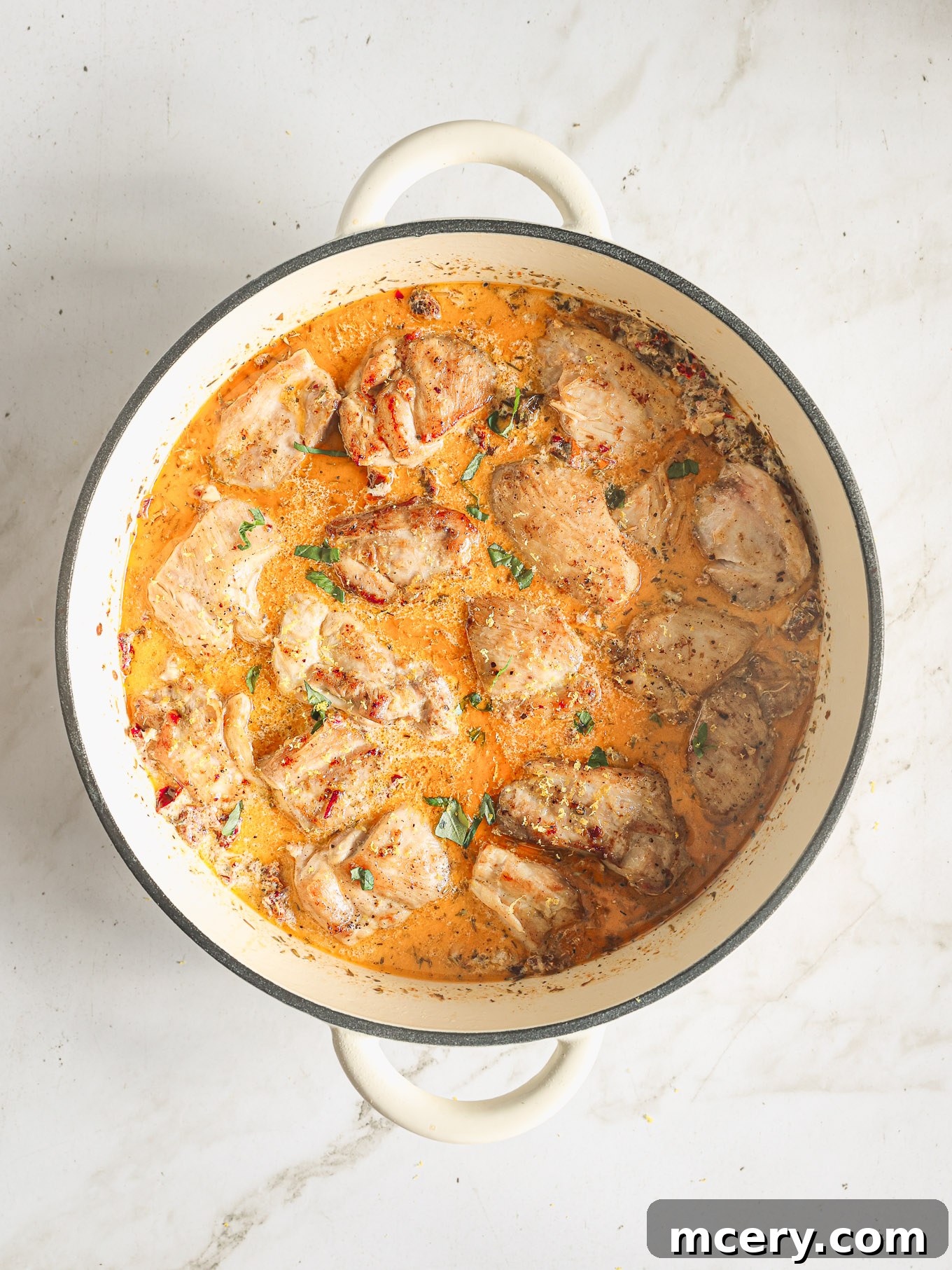 Your Guide to Perfect Marry Me Chicken 9 chicken pieces in cream sauce in a pan.