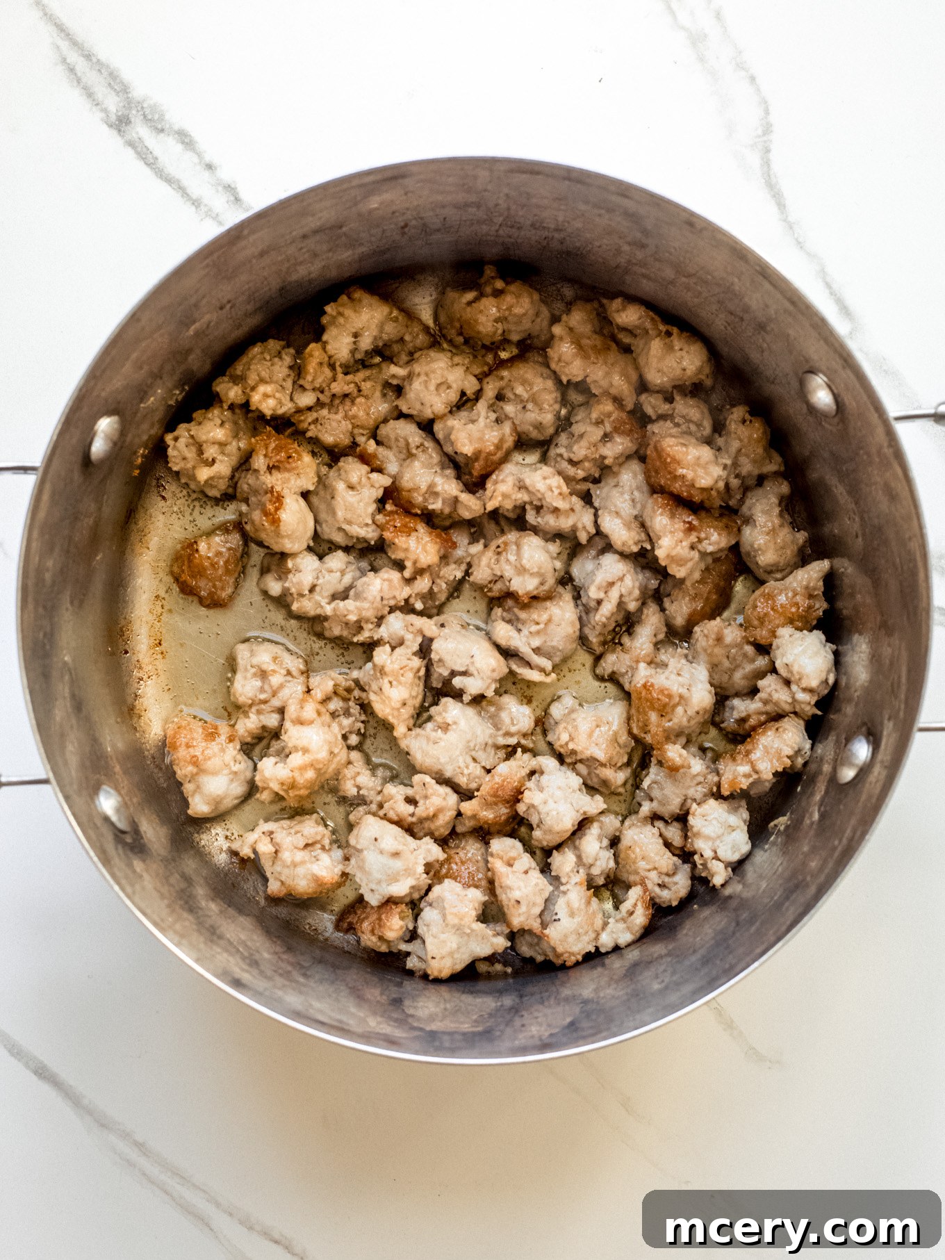 Hearty Italian Sausage Soup 4 Crumbled Italian sausage browning in a large soup pot.