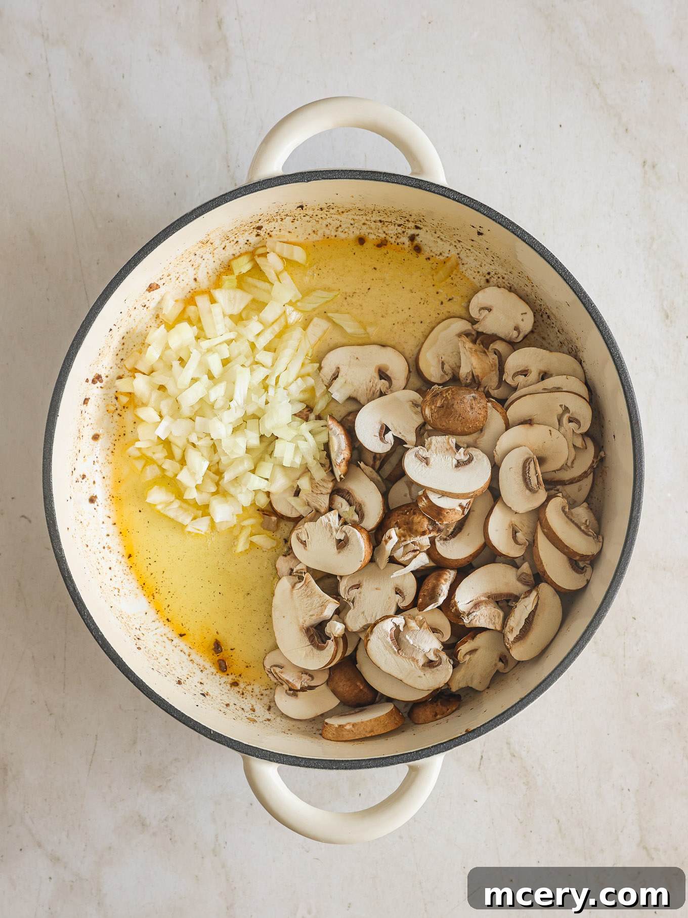 No-Fuss Beef Stroganoff 5 Sautéing sliced mushrooms and diced onions in olive oil and butter in a skillet.