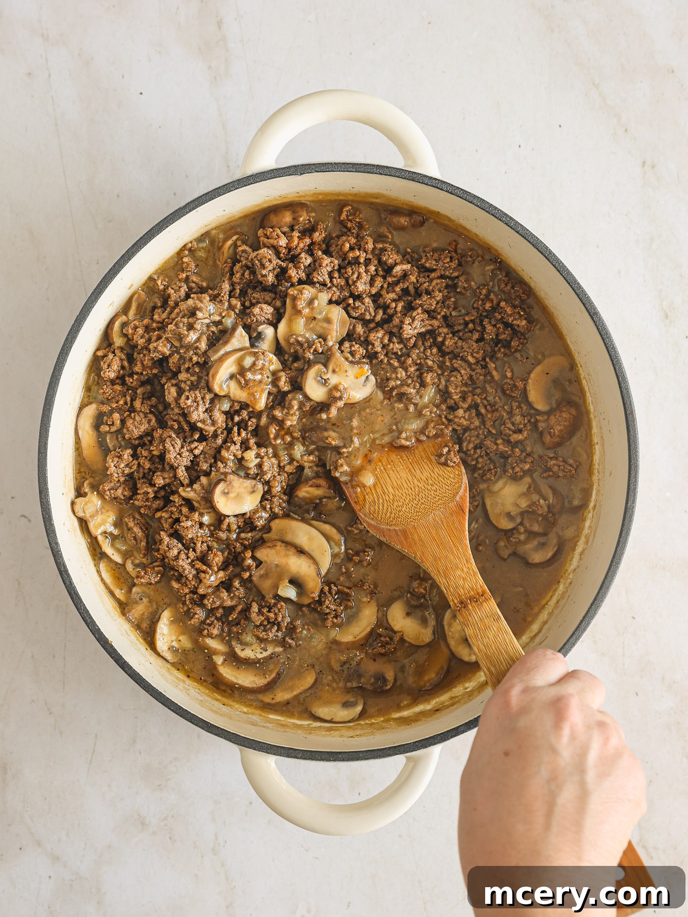 No-Fuss Beef Stroganoff 8 Cooked ground beef being returned to the skillet with the thickened mushroom sauce.