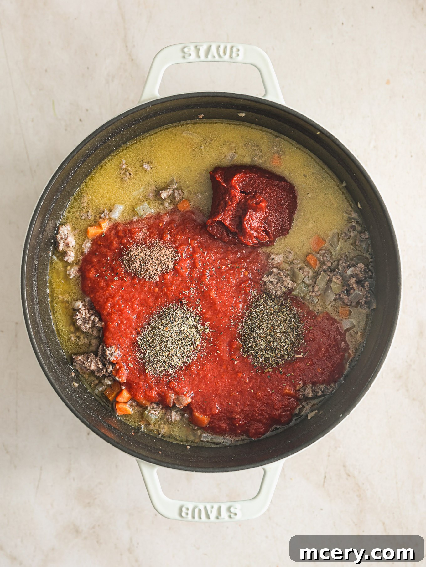 Classic Hearty Bolognese Pasta 8 crushed tomatoes with spices in a dutch oven.