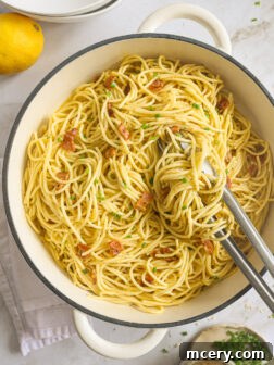 pasta carbonara in a white pan.