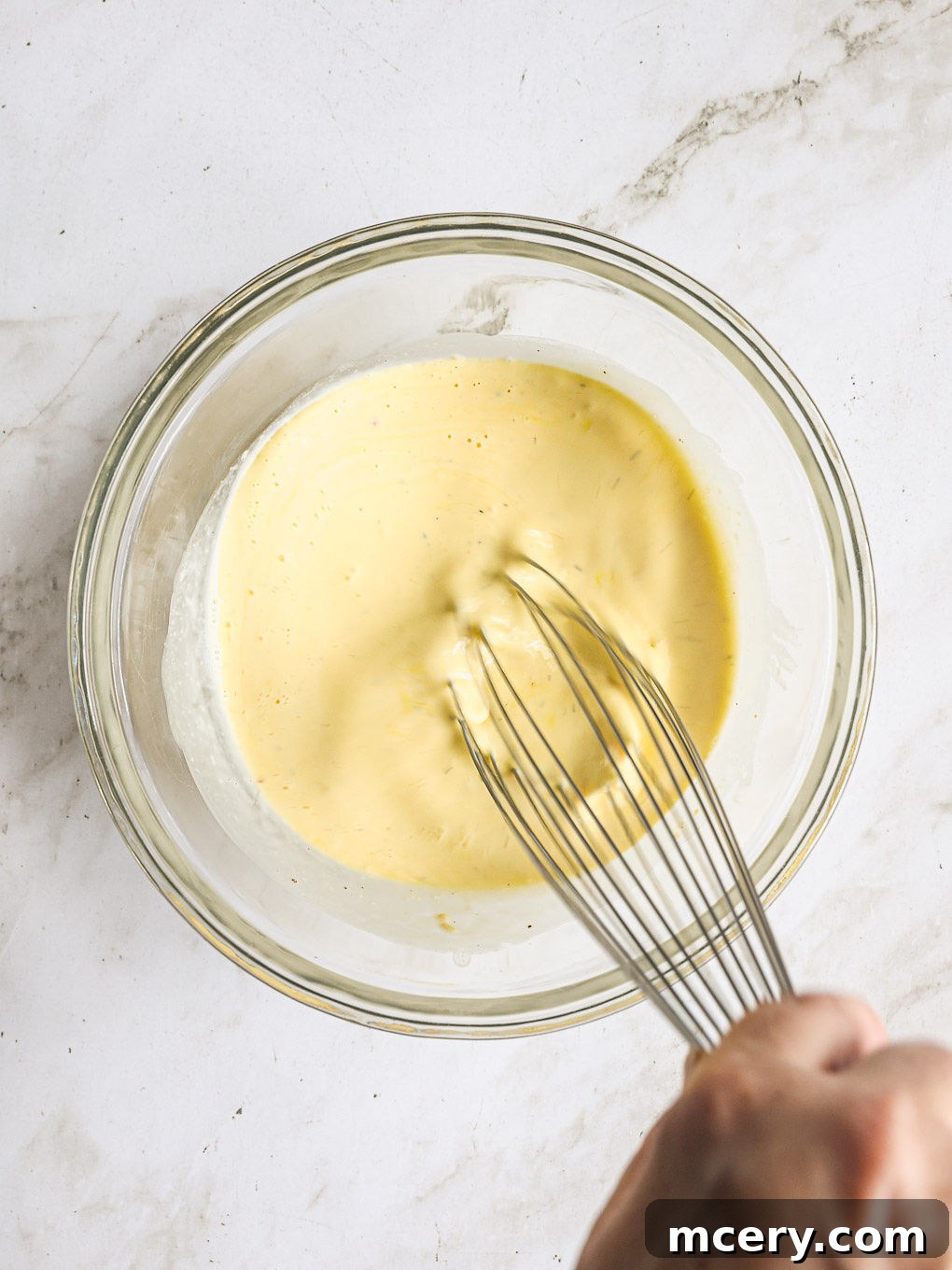 Efsane Hamursuz Kiş Tarifi 7 Eggs, heavy cream, and seasonings whisked together until smooth in a large glass bowl.