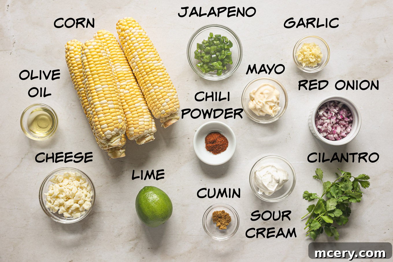 Delicious Mexican Corn Salad From Scratch 3 A collection of fresh ingredients laid out on a table, ready for making Mexican corn salad, including corn, jalapeño, lime, and cilantro.