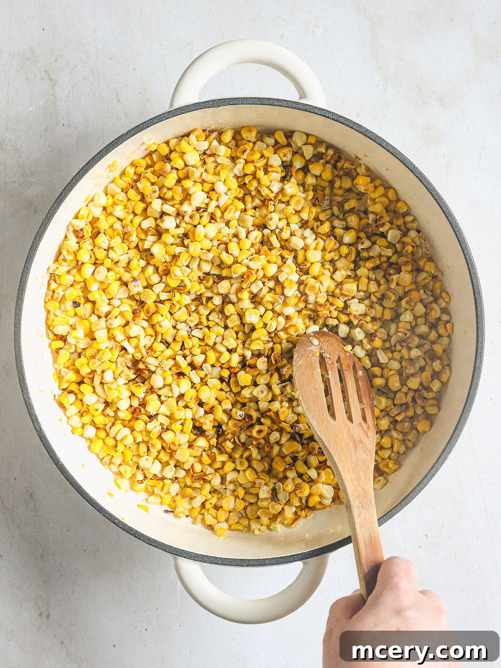 Delicious Mexican Corn Salad From Scratch 4 Fresh corn kernels being charred in a hot cast-iron skillet, turning golden brown and slightly smoky.