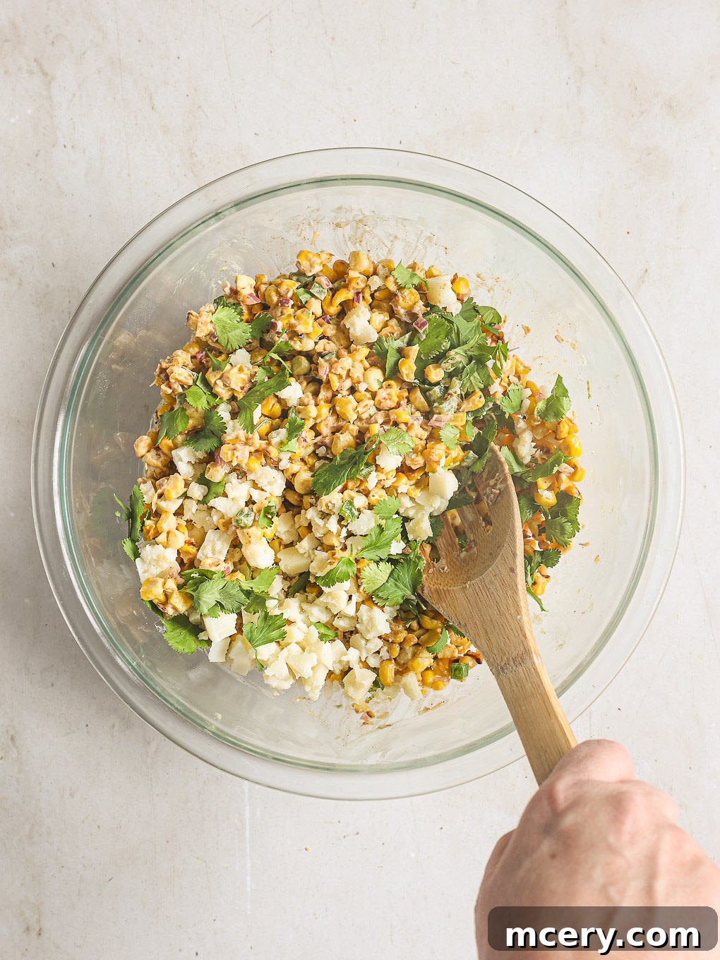 Delicious Mexican Corn Salad From Scratch 7 The fully mixed Mexican corn salad in a bowl, with Cotija cheese and fresh cilantro folded in, showcasing its vibrant colors and textures.