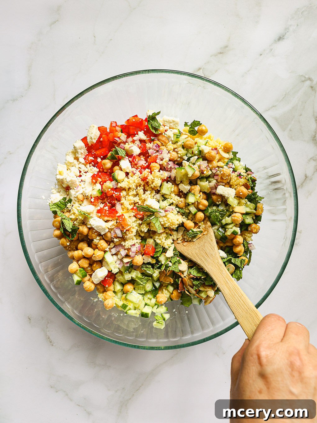 mixed salad in a serving bowl with a spoon.