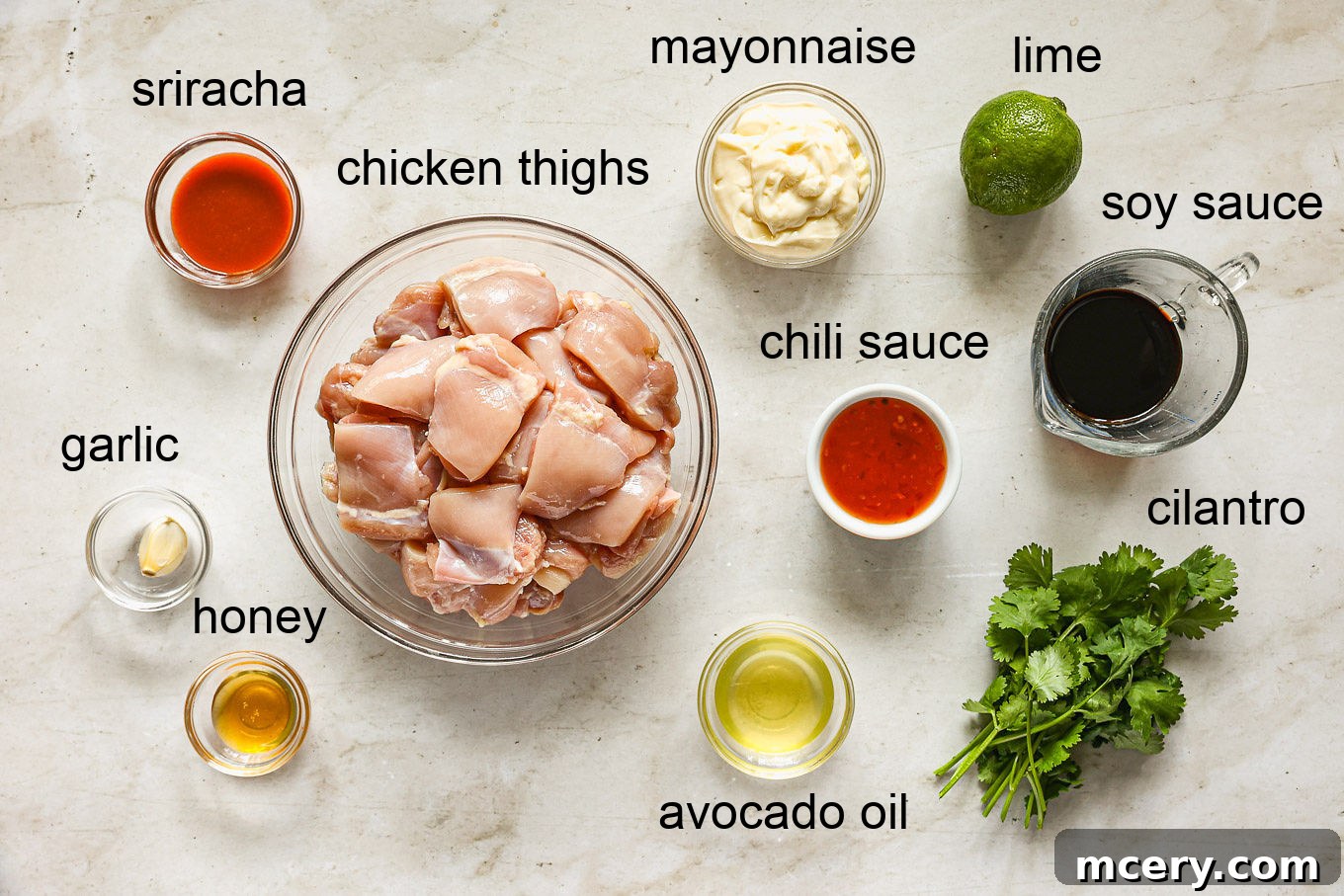 A visual guide to all the fresh ingredients needed for making Bang Bang chicken skewers, including chicken, sauces, and garnishes.