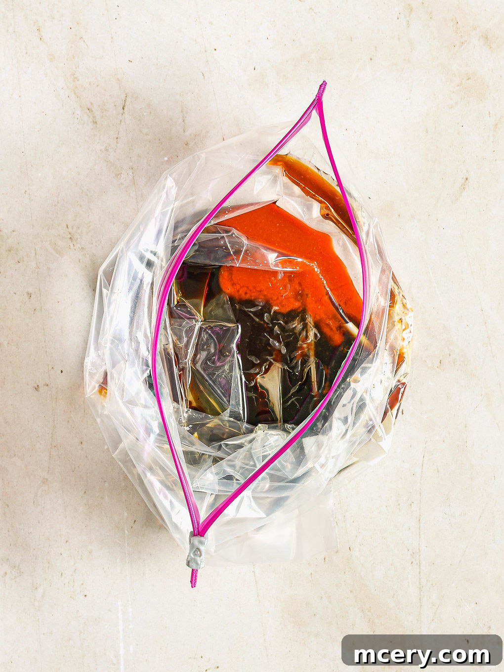 All marinade ingredients being mixed together in a large zip-top bag.