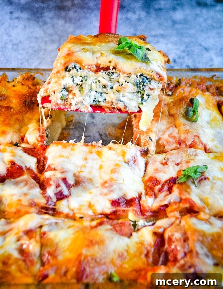 A perfectly baked Easy Spinach Lasagna, golden and bubbly with melted cheese, ready to be portioned and served.