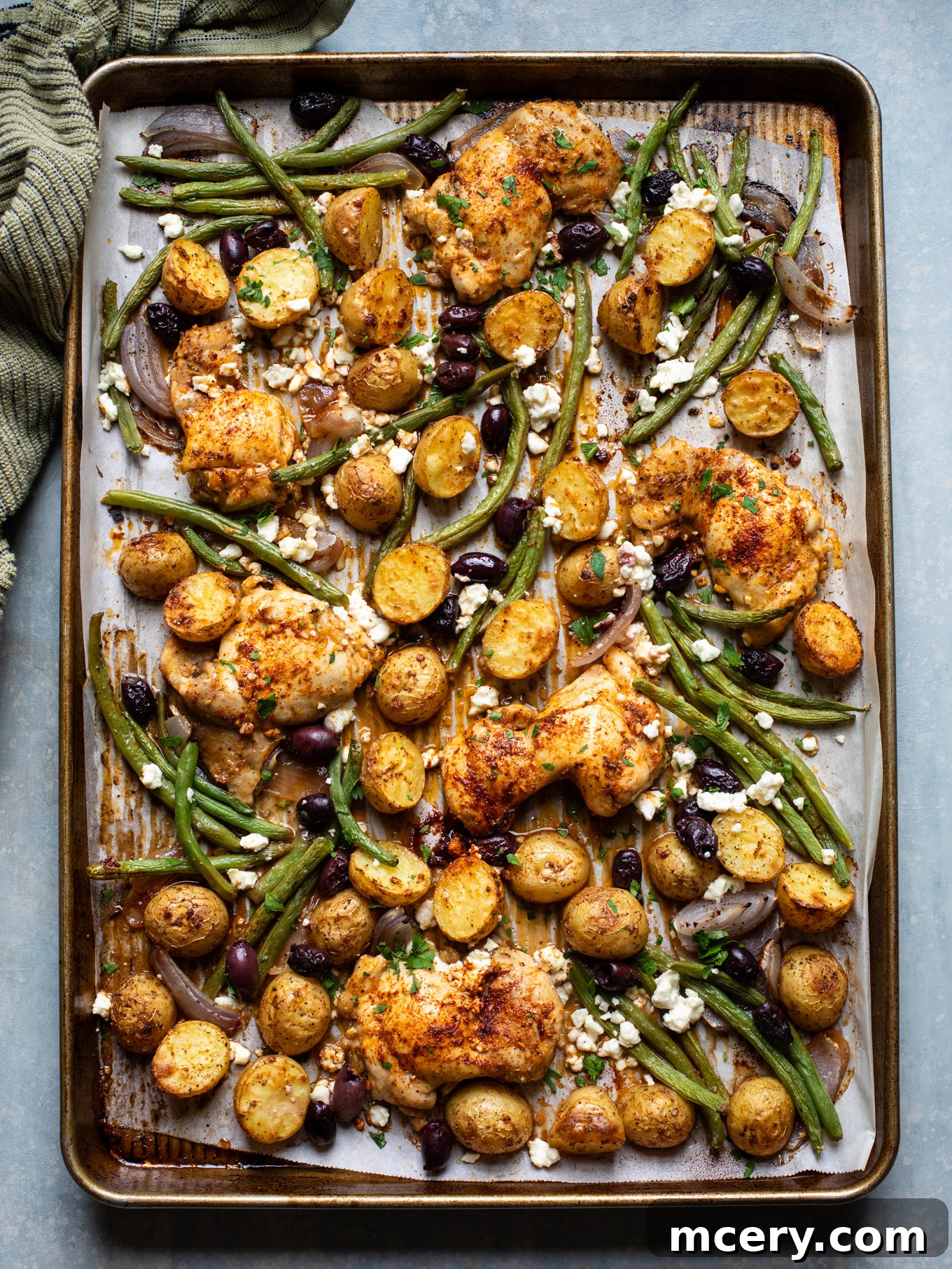 Sheet Pan Lemon Chicken and Mediterranean Vegetables 2 Roasted chicken, potatoes, and green beans on a sheet pan, ready to serve.