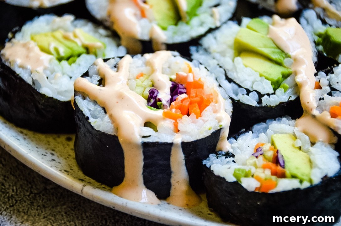 Kaleidoscope Sushi Rolls 4 Assorted Rainbow Veggie Sushi Rolls presented with soy sauce and sriracha mayo for dipping.