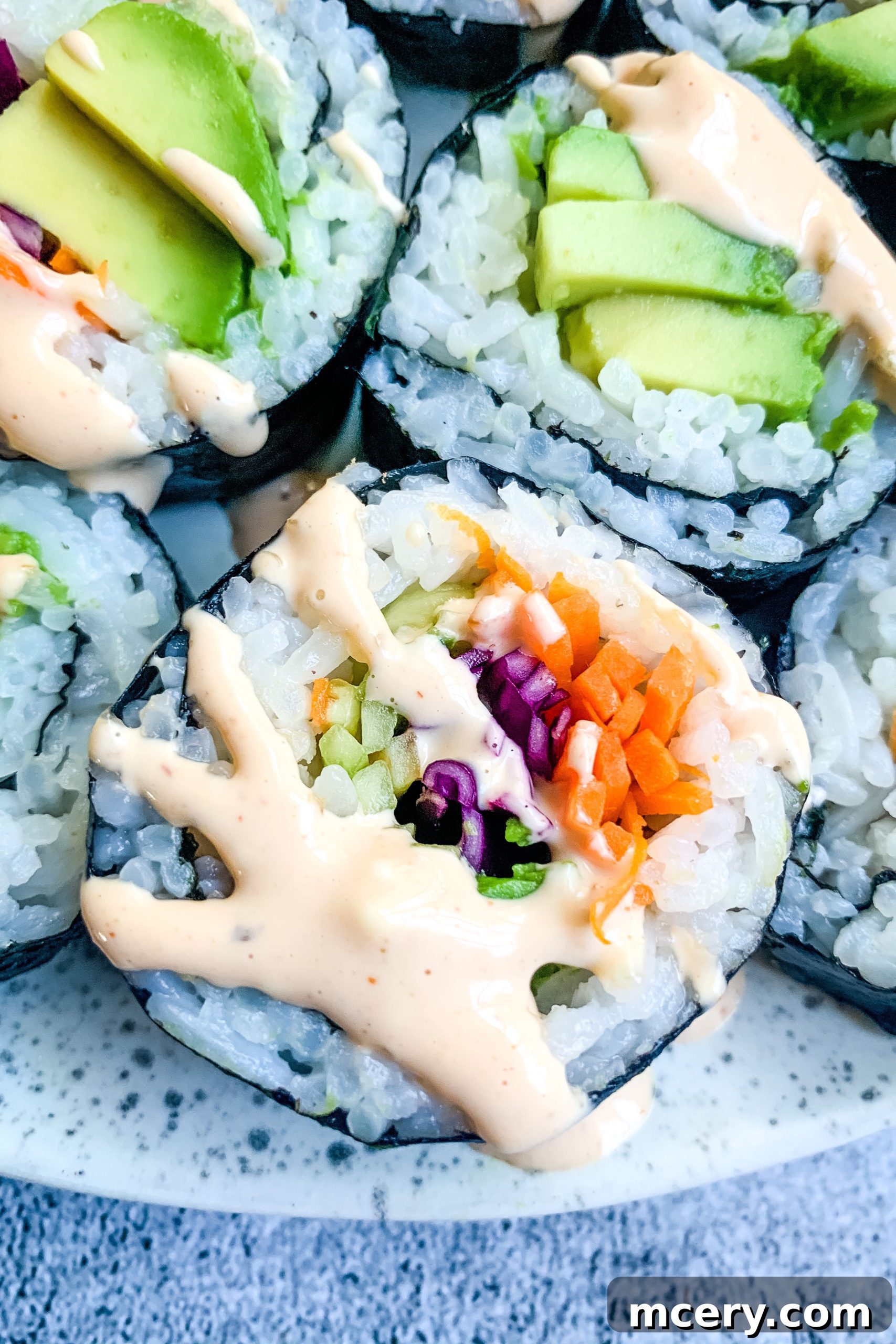 Kaleidoscope Sushi Rolls 5 A beautifully composed shot of freshly prepared Rainbow Veggie Sushi Rolls.