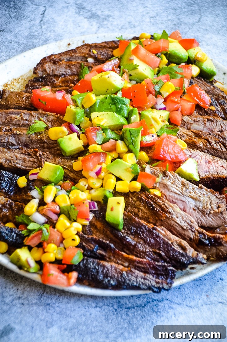 Spice Rubbed Flank Steak with Fresh Avocado Salsa 4 Plated Spice Rubbed Flank Steak & Avocado Salsa, ready to be served