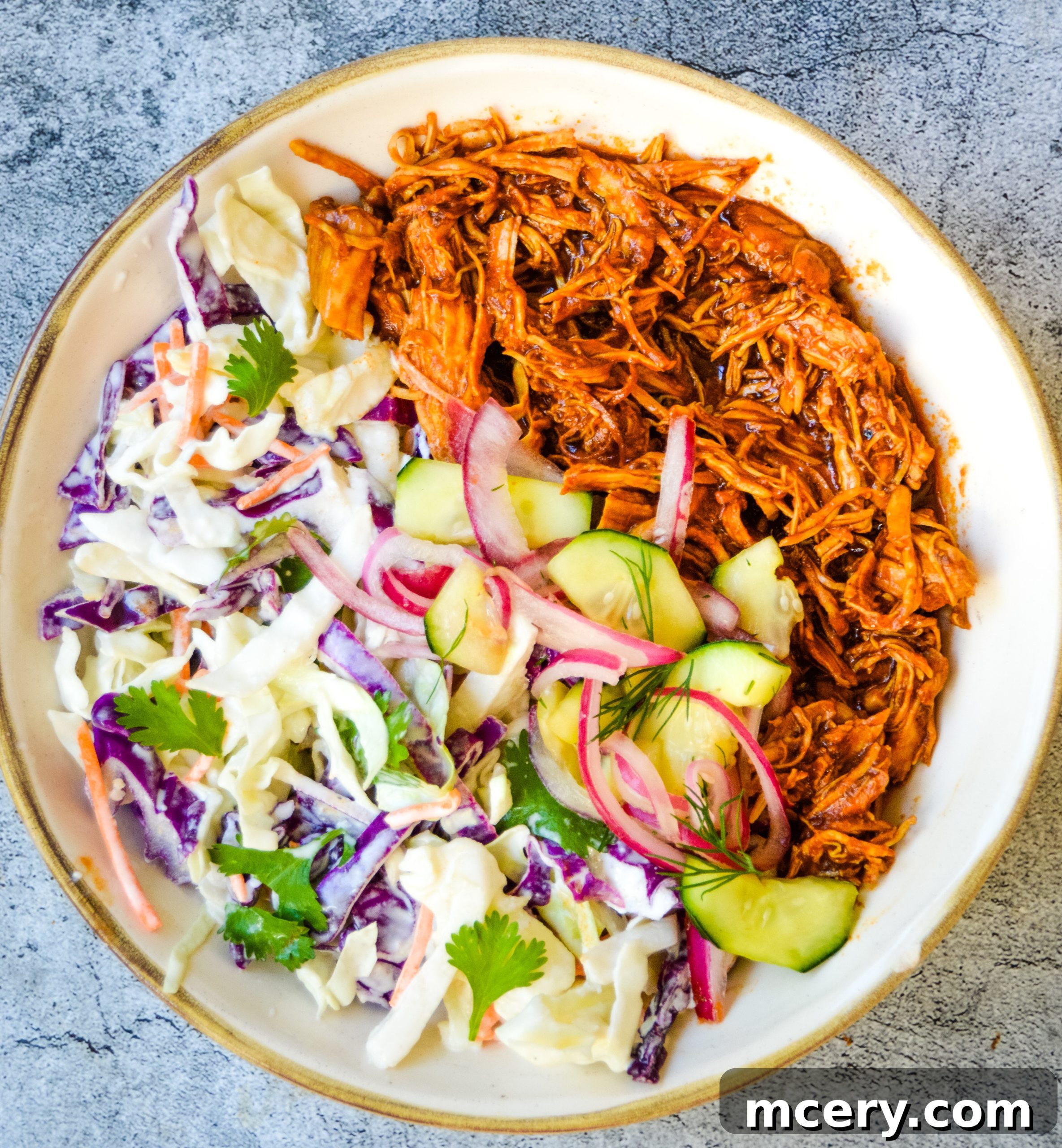 Smoky Pulled Chicken, Crisp Slaw, and Tangy Pickles 4 Three serving suggestions for BBQ chicken and coleslaw: a brioche bun sandwich, a bowl with pickled vegetables, and a separate serving of coleslaw.