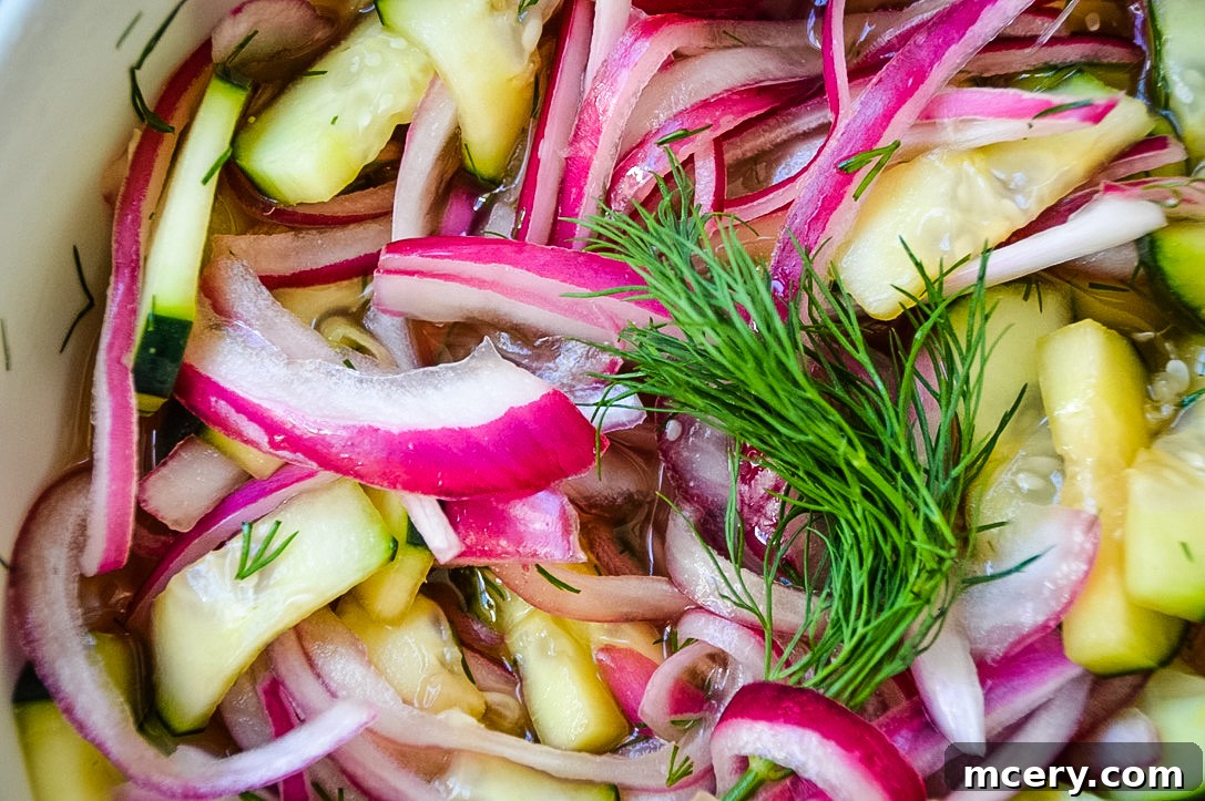 Smoky Pulled Chicken, Crisp Slaw, and Tangy Pickles 7 Ingredients for quick pickled cucumbers and red onions in a bowl, with fresh dill and a jar of pickling liquid.