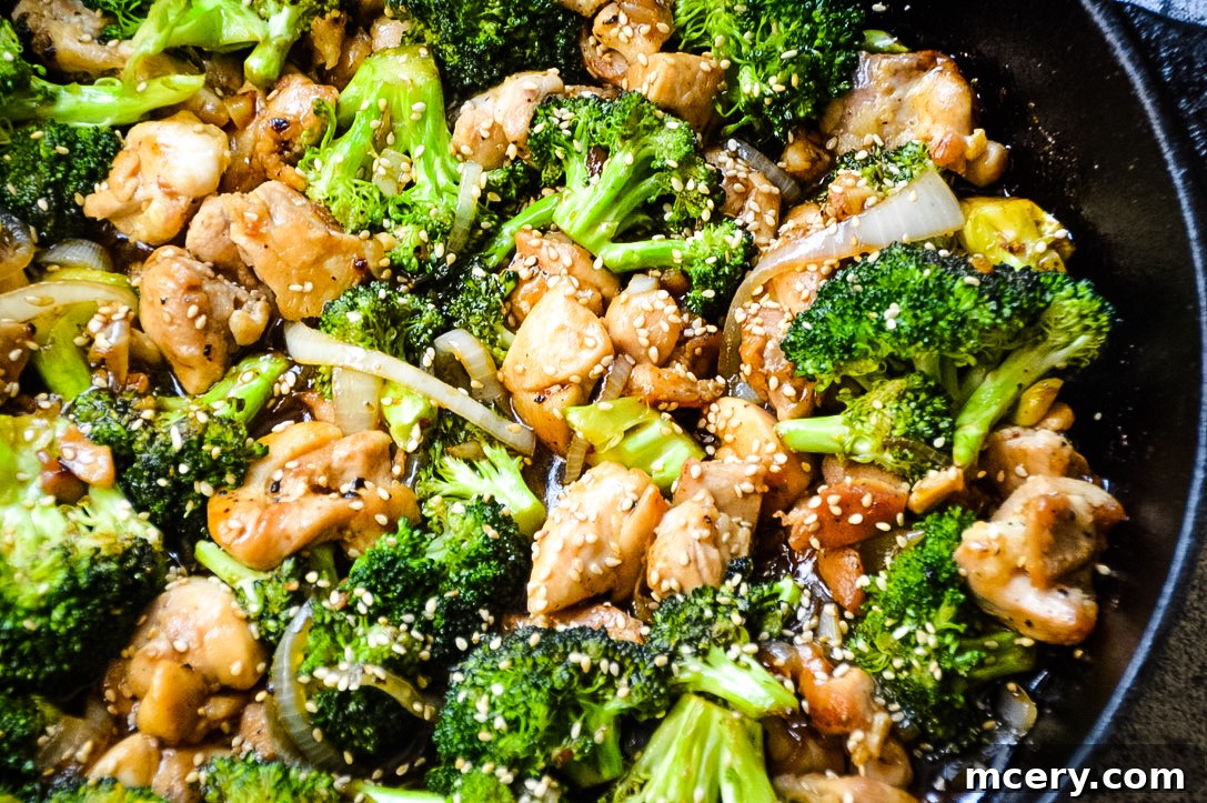 Savory Chicken and Broccoli Stir-Fry 3 A close-up shot of the cooked Chicken and Broccoli Stir Fry, showing succulent pieces of chicken and vibrant green broccoli florets coated in the glossy, aromatic stir fry sauce. The textures are inviting, highlighting the perfectly cooked ingredients.