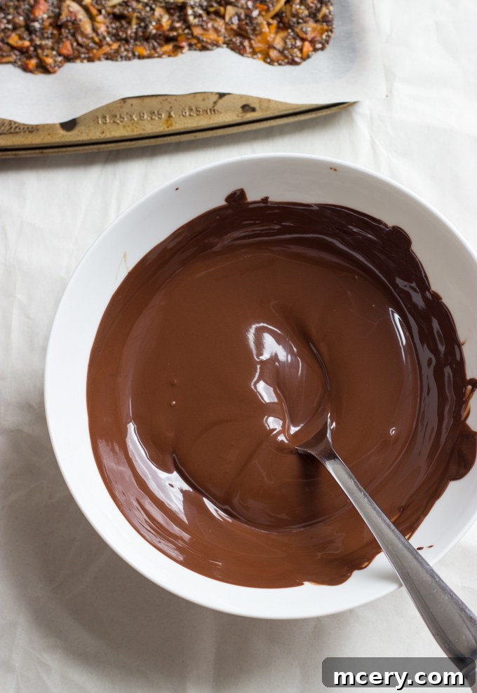 Midnight Almond Bark 6 Smooth, glossy melted dark chocolate in a white bowl, ready to be spread.