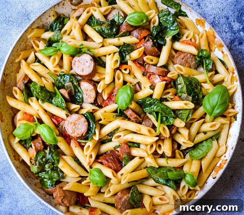 Hearty Tomato Spinach and Sausage Pasta 9 The finished Tomato Spinach and Sausage Pasta, beautifully presented and ready to be served, promising a delightful meal.