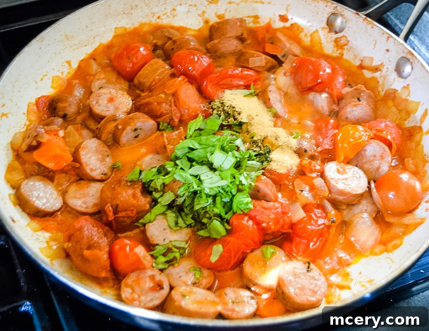 Hearty Tomato Spinach and Sausage Pasta 7 A wide shot of the creamy and flavorful Tomato Spinach and Sausage Pasta, emphasizing its hearty and wholesome nature.