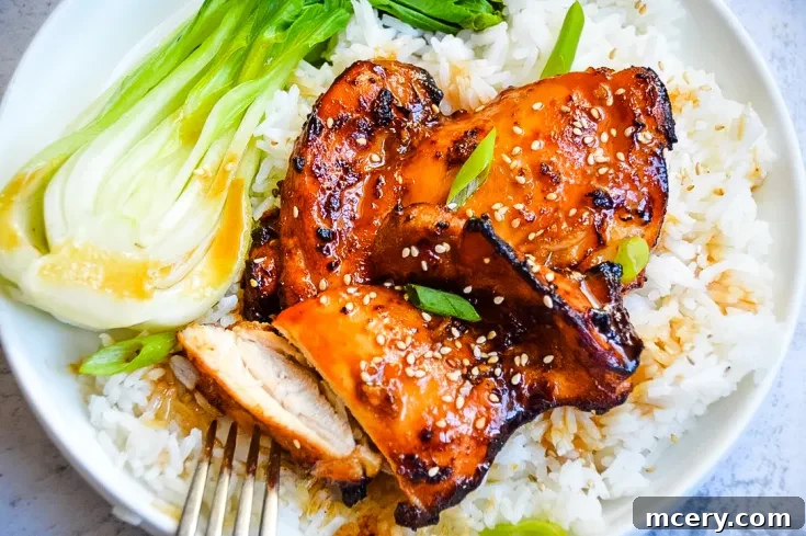Asian Glazed Chicken Thighs on a plate with rice and bok choy, ready to be pinned.