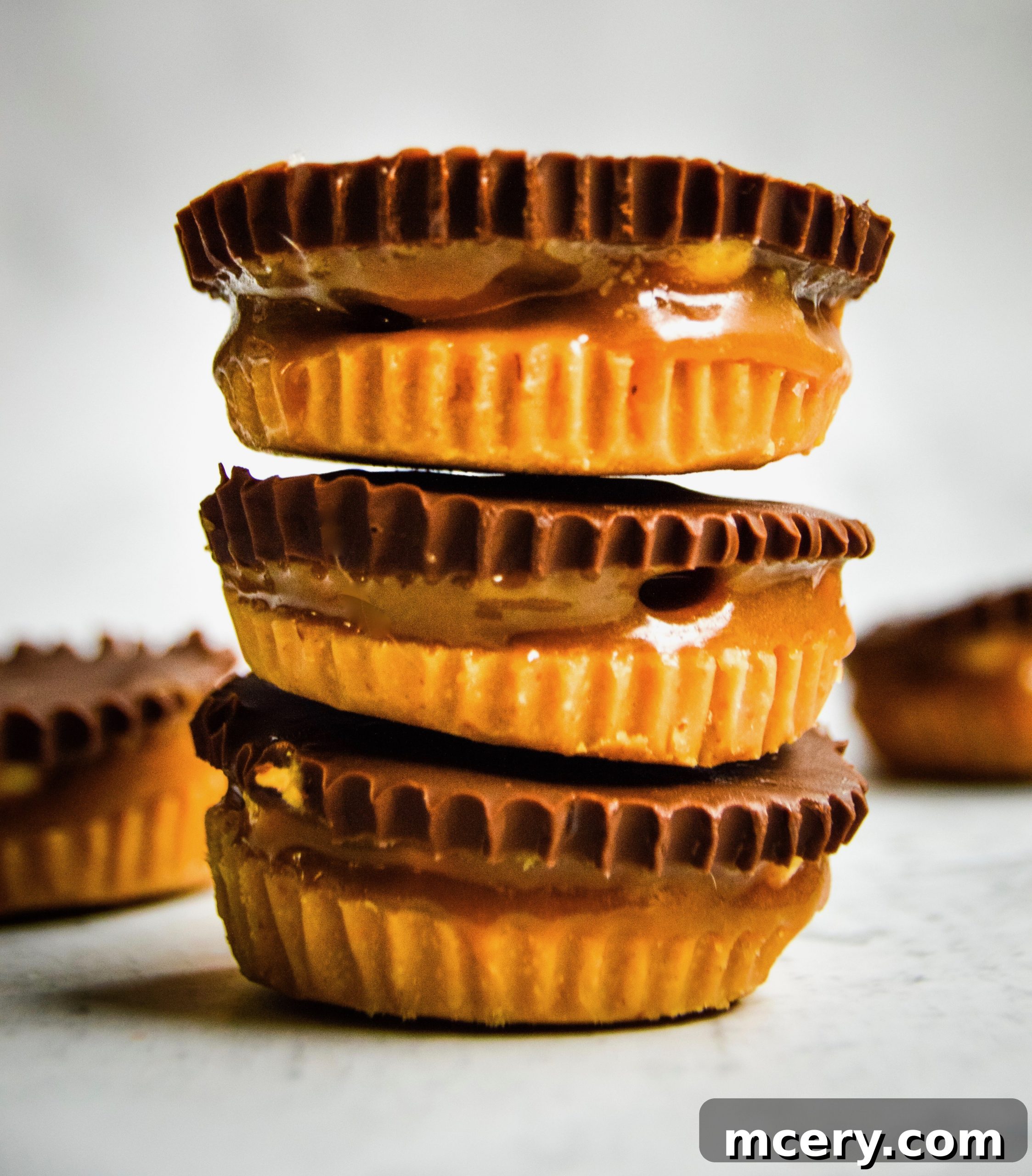 Irresistible Vegan Peanut Butter Caramel Cups 2 Delicious homemade Vegan Peanut Butter Caramel Cups, showcasing their decadent layers of peanut butter, caramel, and chocolate.