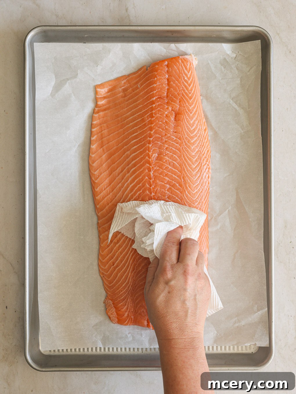 Unlock the Flavor Mastering Blackened Salmon 4 Fresh salmon fillet being gently patted dry with a paper towel, a crucial step for a crispy crust.