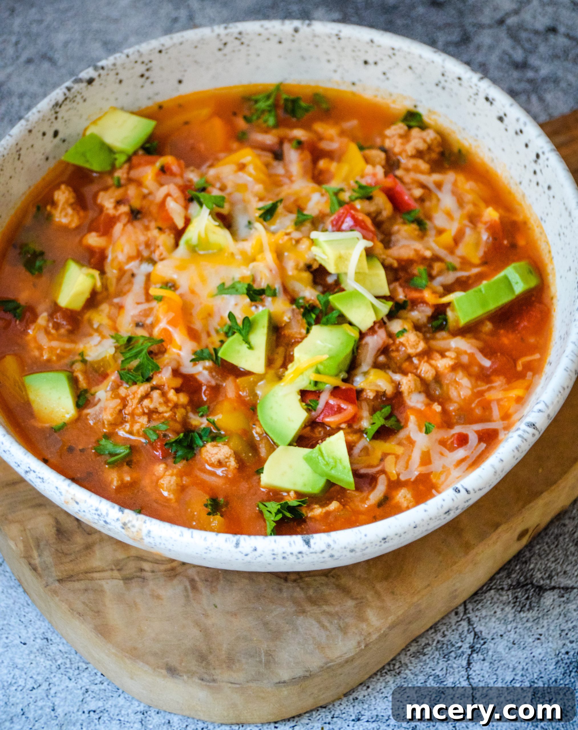 Savory Stuffed Bell Pepper Pot 2 A large pot of rich Stuffed Pepper Soup simmering on a stove, featuring vibrant bell peppers, ground meat, and rice in a savory tomato broth.
