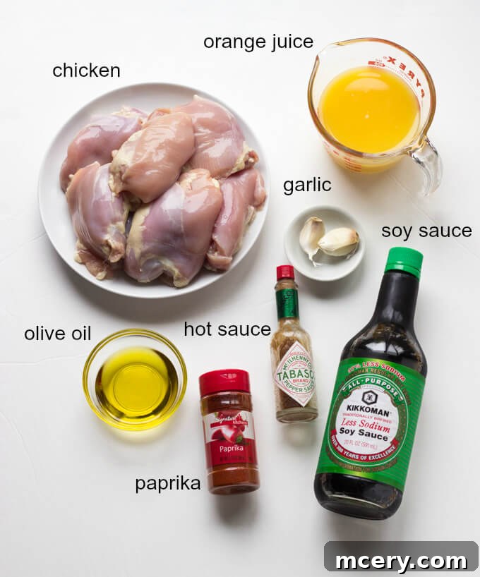Effortless Orange Chicken 3 ingredients for grilled orange chicken recipe, including orange juice, soy sauce, olive oil, garlic, paprika, and hot sauce